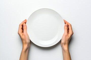 A person holds a white plate above their head, perfect for a photography or food styling concept