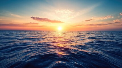 Obraz premium A vast expanse of water with the sun setting on the horizon