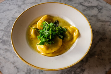 Ravioli in sage and butter sauce with greens or rocket