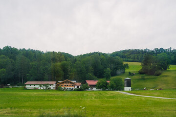 Scenic countryside view featuring traditional buildings surrounded by lush greenery in a tranquil rural setting Konigssee Bavaria German Apls. High quality photo
