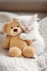 Fototapeta premium adorable baby kitten cat, holding a teddy bear doll, with a warm and cozy feel 