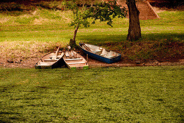 Boats docked by the edge of Lake Bonita in São Paulo, Brazil. The tranquil water and lush greenery...