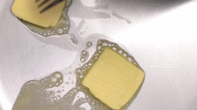 Melting butter in a frying pan creates a rich base for a delicious meal, enhancing flavors and adding creaminess