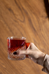 Woman hand holding cocktail glass