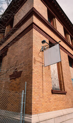 Brick Building with Prominent White Sign on Street Scene