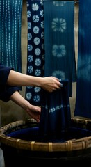 Japanese artisan dyeing fabrics using indigo or yuzen techniques, with vibrant blue hues and detailed patterns in a naturalistic workshop.