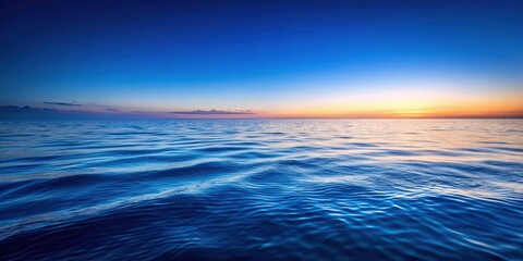 Obraz premium A calming seascape with gentle waves reflecting the golden hues of a fading sunset, creating a serene and tranquil atmosphere