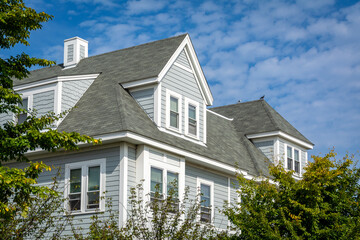 Newly built classic style family house with hipped and gabled dormers in Brighton, Massachusetts,...