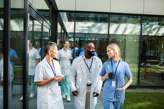 Medical professionals discussing in hospital hallway