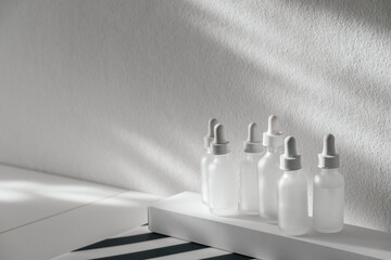 Frosted Glass Cosmetic Serum Bottles With Dropper Pipette Dispenser On White Rectangular Box,...