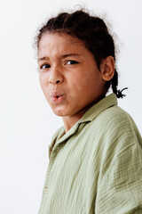 Obraz premium Young african american boy making silly faces in a playful and trendy portrait session