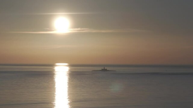 Aerial drone shot of the Forte do Bugio lighthouse, Tagus river, Atlantic Ocean and horizon at sunset from Lisbon, Portugal, Europe. Shot in ProRes 422 HQ