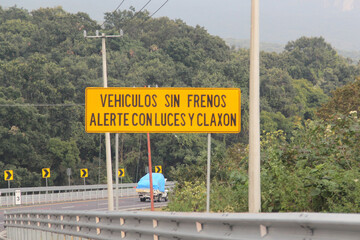 Sign on the highway to indicate a braking ramp to stop vehicles that have lost control of their...