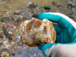 Quartz druse on a flint fragment in hand, rockhounding, field photo