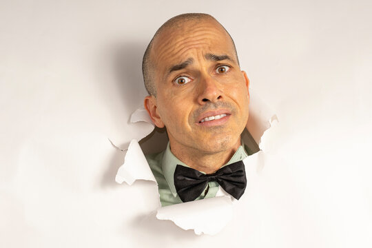 48 year old man in casual clothing and a bow tie, with only his head on a cardboard, showing emotions_9.