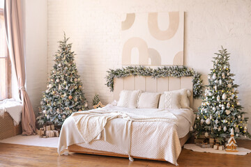 Bright modern bedroom decorated with fir garlands and Christmas trees. Interior in warm minimalism style.