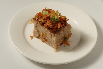 Malaysia style steamed yam cake on a white plate.