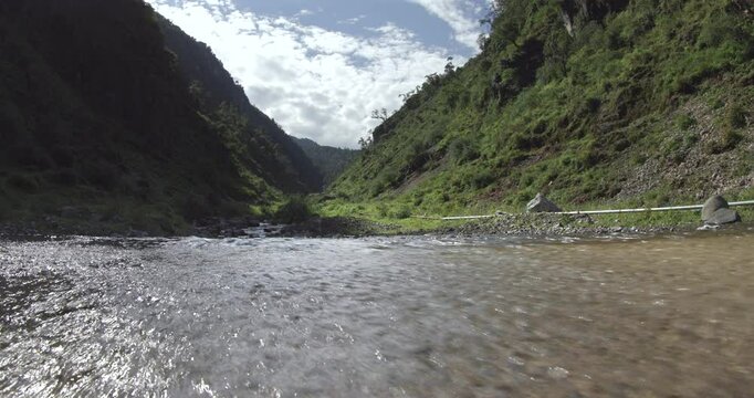 A beautiful river flows through the heart of a mountainous gorge