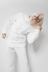 Fashion model in futuristic attire, striking a dynamic pose against a plain white background,...