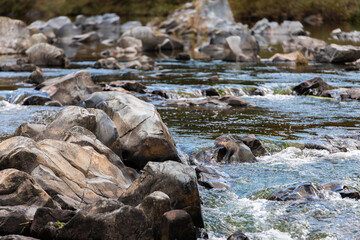 rocks and flowing water in the autumn stream