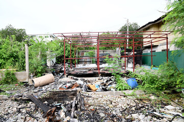 BANGKOK, THAILAND - November 15, 2024: Debris from a house after a fire caused by an electrical short circuit with natural background at Thailand.