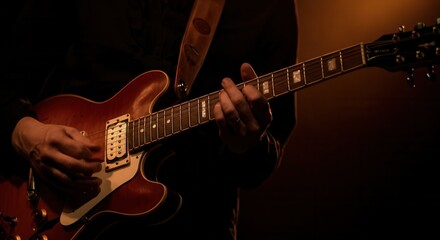 Fototapeta premium A talented musician skillfully plays an electric guitar, captivating the audience with their passion and technique. The warm stage lights create an inviting atmosphere, enhancing the live music experi