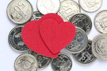 Coin with double heart shape object. Concept on love of money. Isolated on white background Concept...