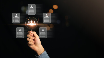 Fototapeta premium HRM or Human Resource Management,Strategic planning for success through people business development concept by choosing professional leaders employee competency Teamwork,magnifying glass in human hand