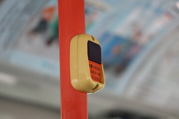 Japanese bus with a button to press when passengers are going to get off at the next stop