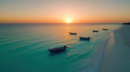 A scenic shot of a Cancun beach at sunrise, with small fishing boats anchored in the shallow, crystal-clear water