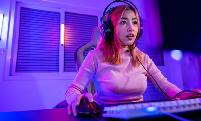 Young player woman wearing gaming headphones intend to do playing live stream games online at home,...