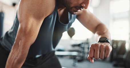 Health, gym and man with time, watch and heart rate check with clock and runner stats. Stopwatch,...