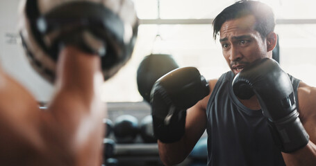 Boxing gloves, men and personal trainer in gym with workout, power and training for sport and...