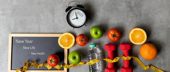 New Year for New Changes Healthy 2025.  Fresh vegetable fruits and healthy food for sport equipment...