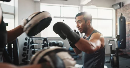  Boxing, man and personal trainer in fitness gym with workout, power and training for sport and strength in club. Coach, health and sweating athlete and boxer with exercise for fight and match © peopleimages.com