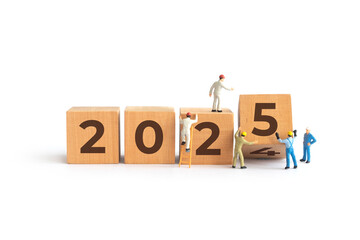 Transitioning from 2024 to 2025 with wooden blocks and miniature people. new year 2025 concept.