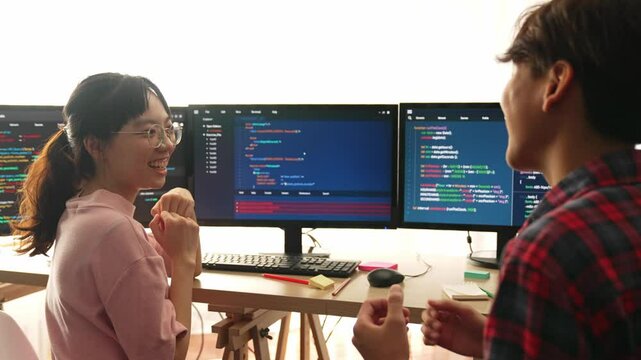 Back end software developer engineer for computer programming working together on debugging writing computing code, solving complex algorithms display on monitor in office. Burgeoning