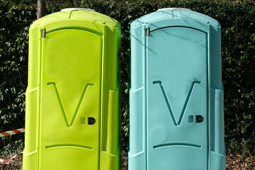 Chemical toilets on a construction site. Workers' hygiene.  -  Two colored plastic boxes used as toilets. 