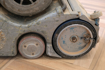 Sanding wooden floor. Parquet renovation.  -  Old parquet sanding machine on a construction site. 