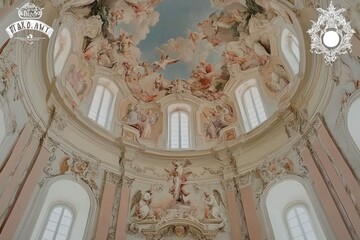 A beautifully decorated dome featuring intricate frescoes and natural light.