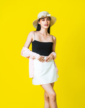 Trendy Western Lady Modeling Black and White Outfit Mockup With a Yellow background