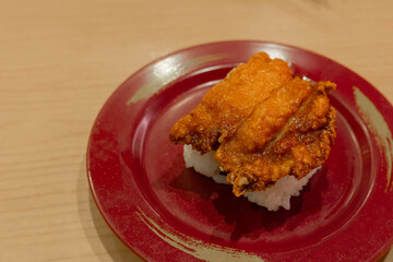 Crispy chicken sushi  serving on red plate. creative sushi menu. serving on red plate