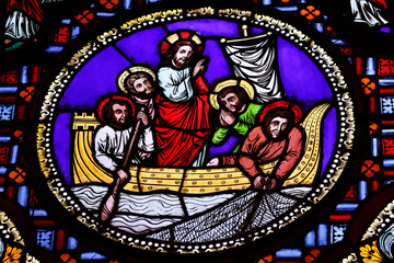 Obraz premium Saint Martin d'Ainay basilica. Stained glass window. Jesus and his apostles fishing. The Miraculous catch of fish. Lyon. France.