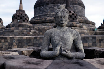Obraz premium Borobudur, 9th-century Mahayana Buddhist temple. UNESCO World Heritage. Stone Buddha statue. Java. Indonesia.