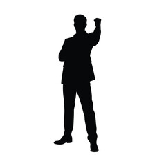 A man in a suit is standing in front of a white background. He is wearing black shoes and a black jacket