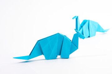 Paper dinosaur on white background. paper crafts. origami dinosaur. origami art. © Denis