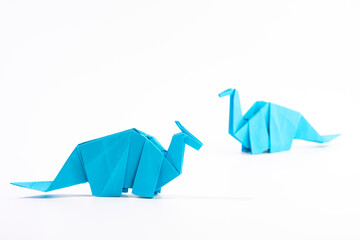 Paper dinosaur on white background. paper crafts. origami dinosaur. origami art. © Denis