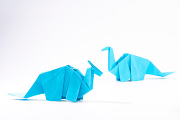 Paper dinosaur on white background. paper crafts. origami dinosaur. origami art.