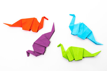 Paper dinosaur on white background. paper crafts. origami dinosaur. origami art.