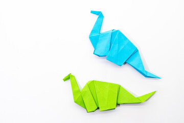 Paper dinosaur on white background. paper crafts. origami dinosaur. origami art.